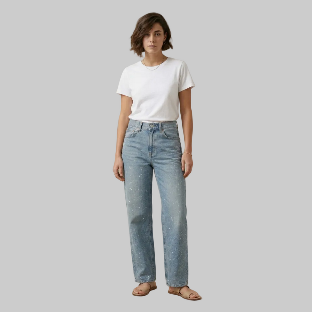 Front view of light blue denim jeans featuring a high-waisted fit and white paint fleck distressing on a female model.