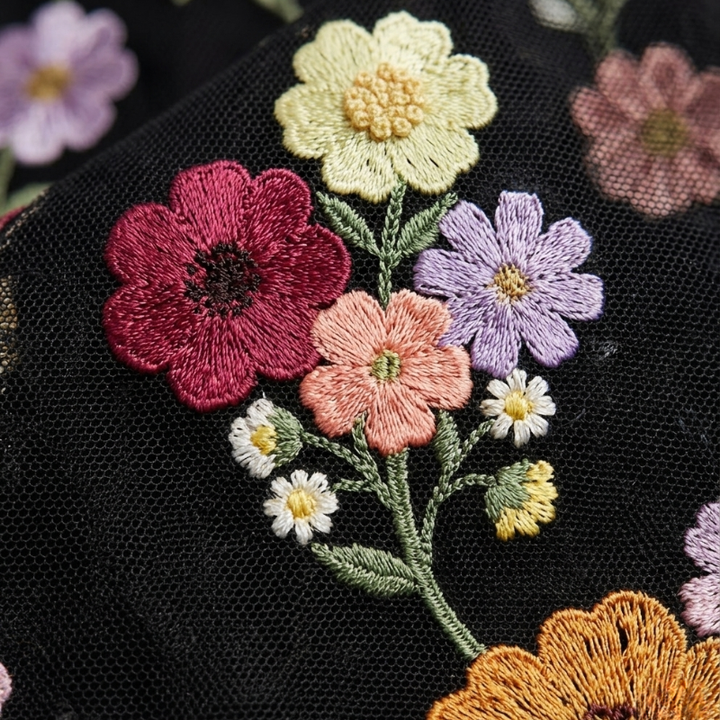 Embroidered flowers on a black fabric background