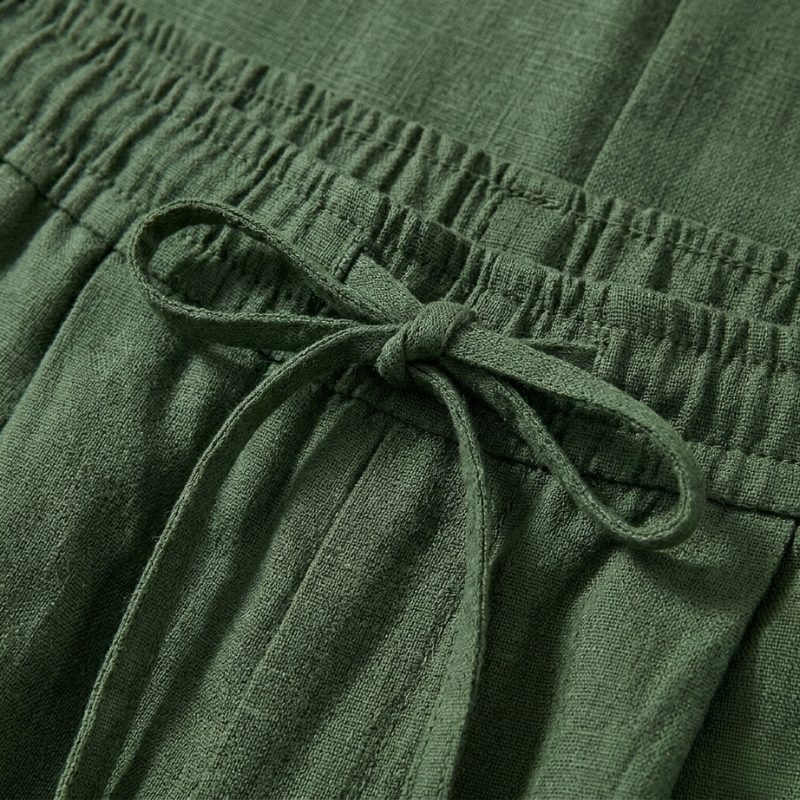Close-up of green fabric with a tie detail
