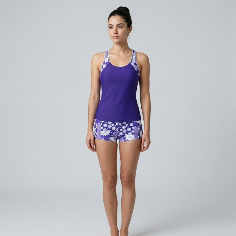 Front view of a royal blue tankini swimwear set featuring a floral-trimmed racerback top and shorts.