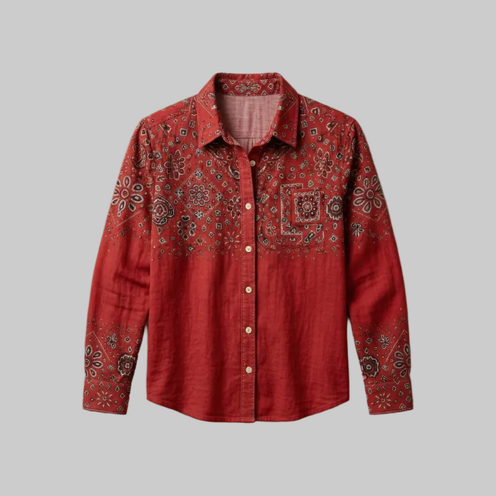 Flatlay studio shot of a red long-sleeve shirt featuring detailed embroidery on the chest and sleeves.